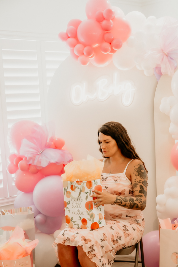 6G4A5329 Mother-to-be opening up her baby gifts.