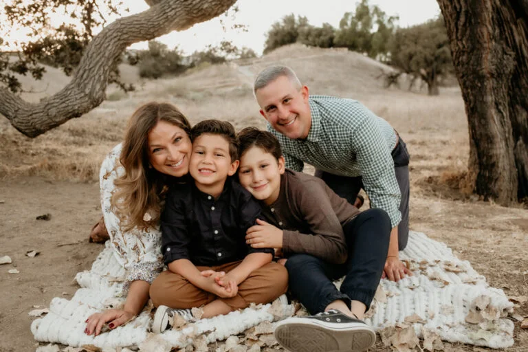 " Natural light holiday family portrait of mom, dad, and two young brothers photographed by a Los Angeles and Santa Clarita family photographer"